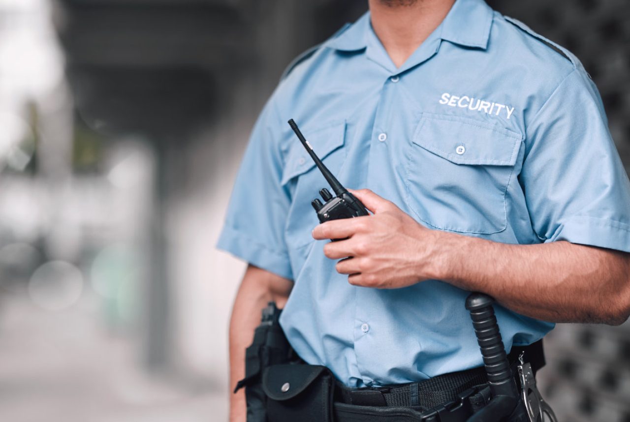Walkie talkie, security guard or safety officer man on the street for protection, patrol or watch. .